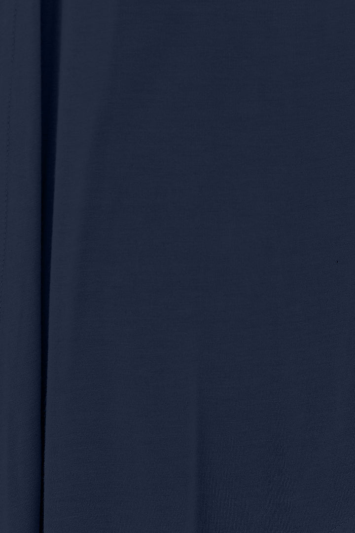 A close-up view of the Basic Bae Full Size Open Front Long Sleeve Cardigan in dark blue rayon spandex fabric reveals a slightly textured surface with vertical folds and shadows, highlighting its basic style and slightly stretchy draping.