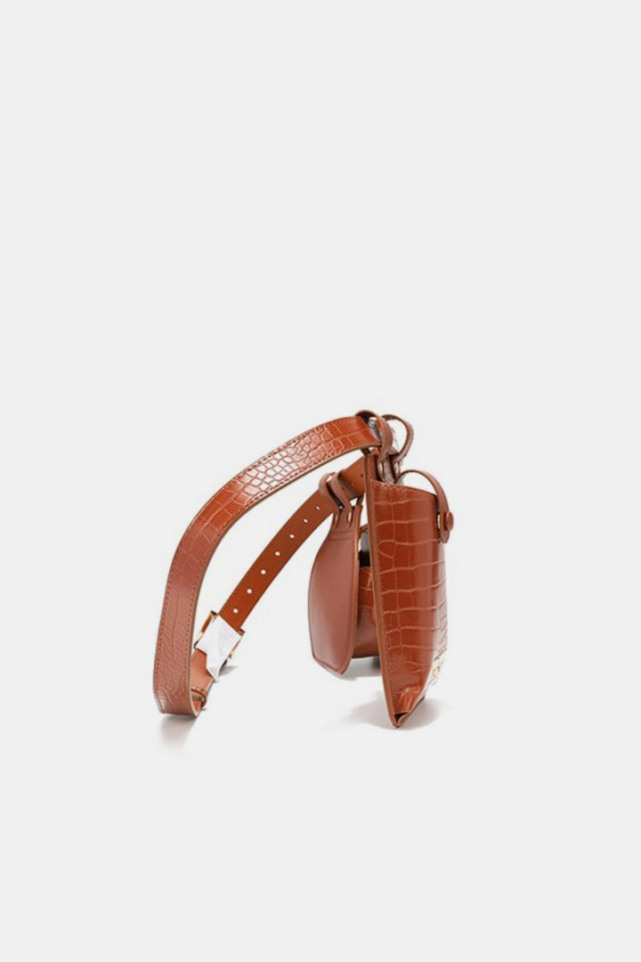 The Nicole Lee USA 2 Piece Texture Belt Bag, crafted from brown crocodile-embossed vegan leather, includes two pouches—one large and one small—and features an adjustable strap for a customizable fit. Displayed upright against a plain white background.
