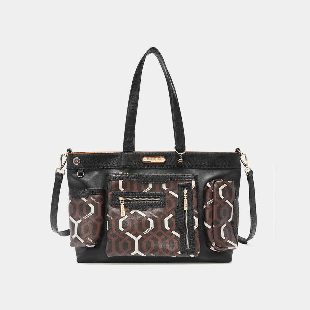 The Nicole Lee USA Geometric Pattern Large Handbag is a black vegan leather tote with double handles, gold zippers, a detachable shoulder strap, and two front pockets featuring brown, white, and black geometric patterns.