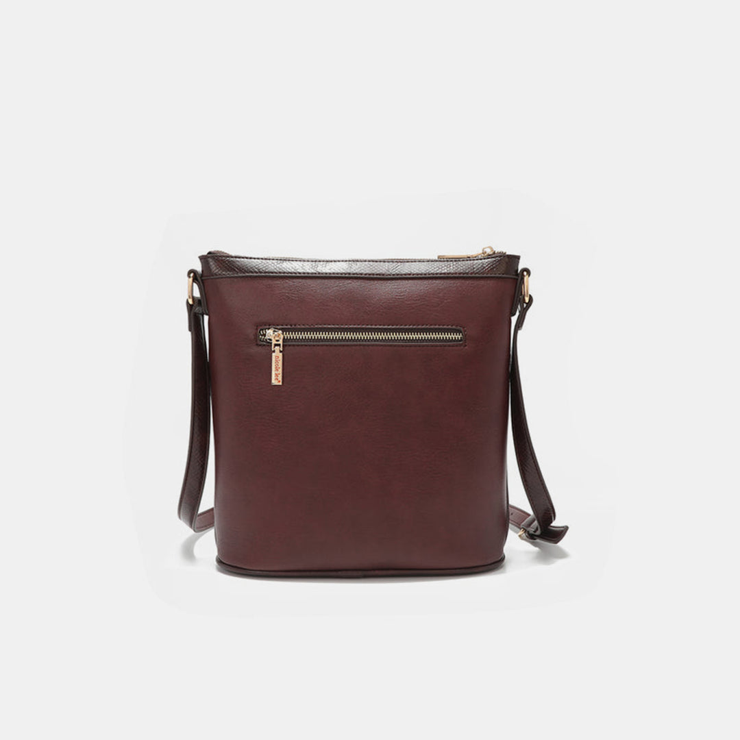 The Nicole Lee USA Metallic Stitching Embroidery Inlaid Rhinestone Crossbody Bag is crafted from brown vegan leather featuring rhinestones, a zippered front pocket, and an adjustable shoulder strap, displayed against a plain white background.