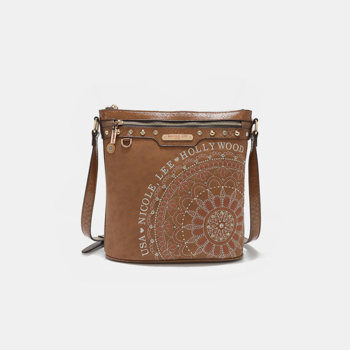 The Nicole Lee USA Metallic Stitching Embroidery Inlaid Rhinestone Crossbody Bag showcases a bohemian aesthetic with intricate white mandala designs on brown vegan leather. It features multiple zippers, button details, and a shoulder strap for crossbody wear, with Nicole Lee Hollywood USA embossed on the front.