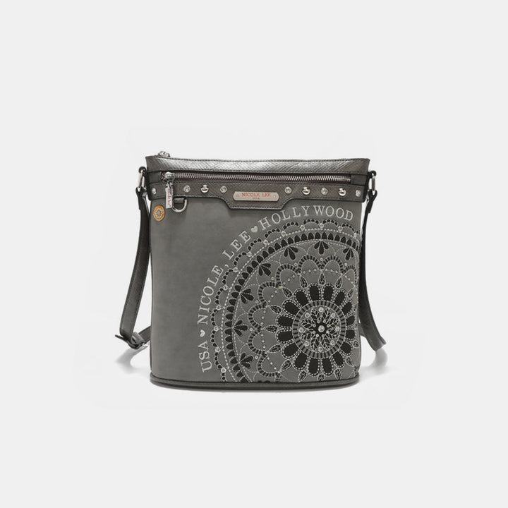 Nicole Lee USA crossbody bag with black and white mandala design, vegan leather, top zipper, leather strap, metallic accents, small tag, and zipper pocket.