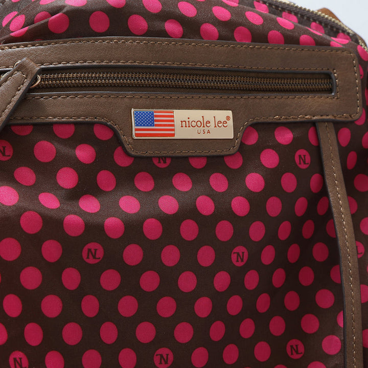 A close-up of the Nicole Lee USA Metallic Stitching Embroidery Inlaid Rhinestone Crossbody Bag shows a brown design with pink NL-dotted polka dots. It includes a leather zipper with a nicole lee USA tag, an American flag above the name, and vegan leather accents.